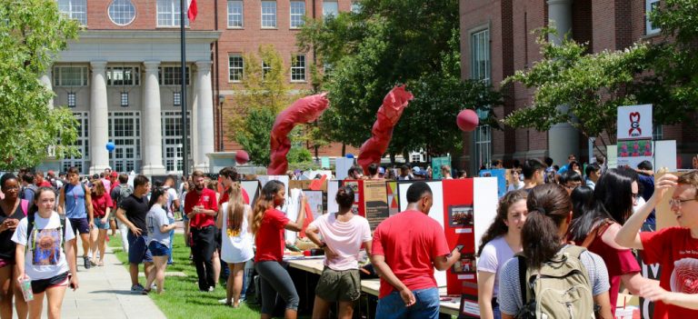 Students are visiting and talking at student organization tables